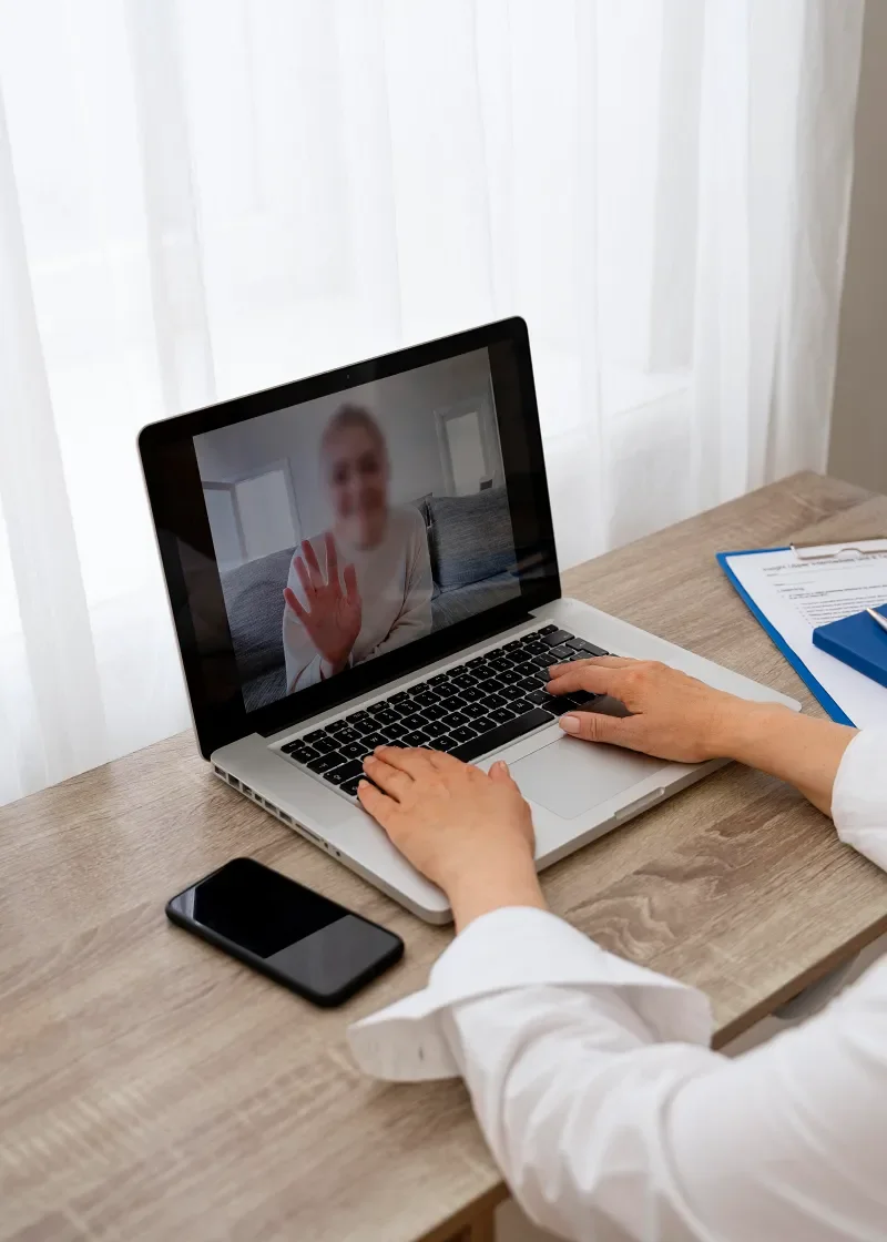 Person attending a virtual medical intake appointment on a laptop.