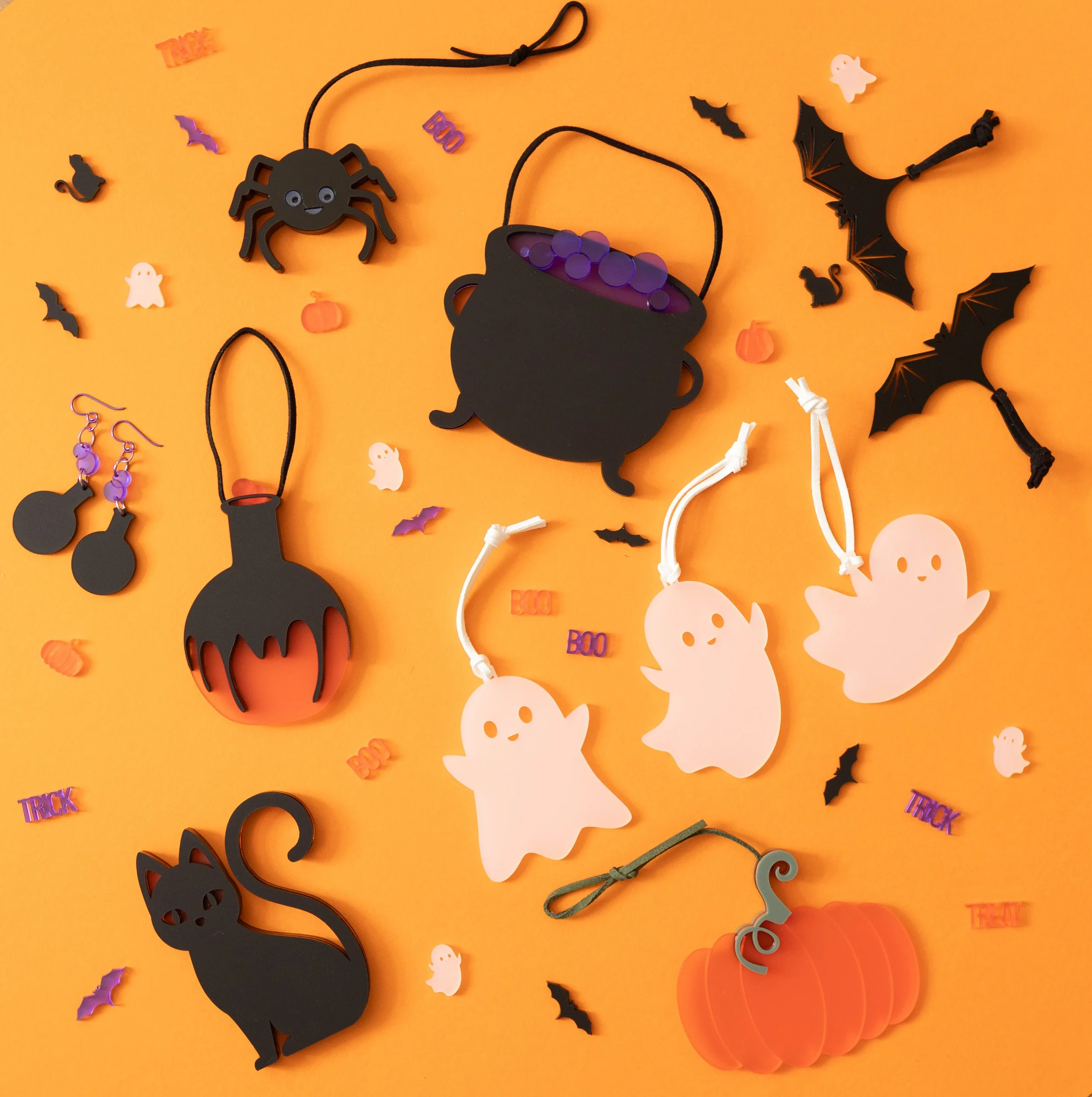 A selection of halloween decorations on an orange background