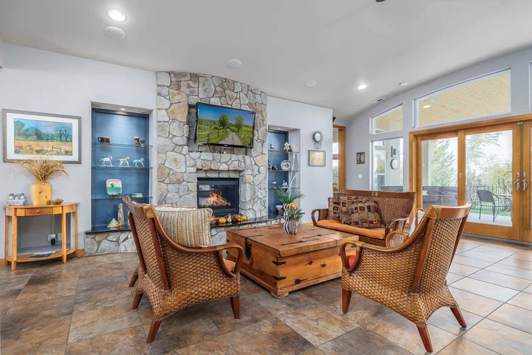 Great room with a stone fireplace and leather chairs