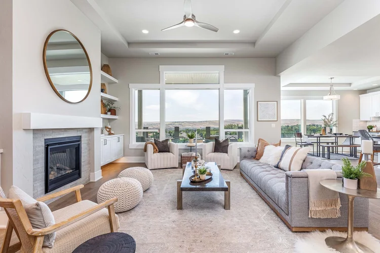Bright living room with a fireplace and large windows in a Tri-Cities home