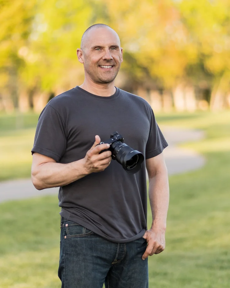Jared Quinlan, founder of Quinlan Images, holding a camera