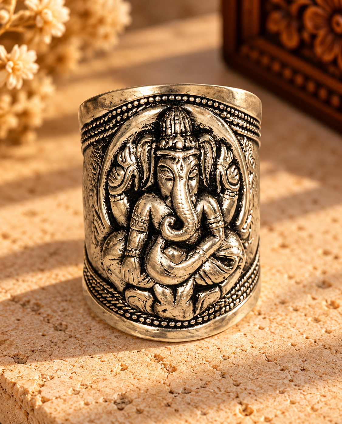 Ornate Silver Ganesha Ring on Stone.png