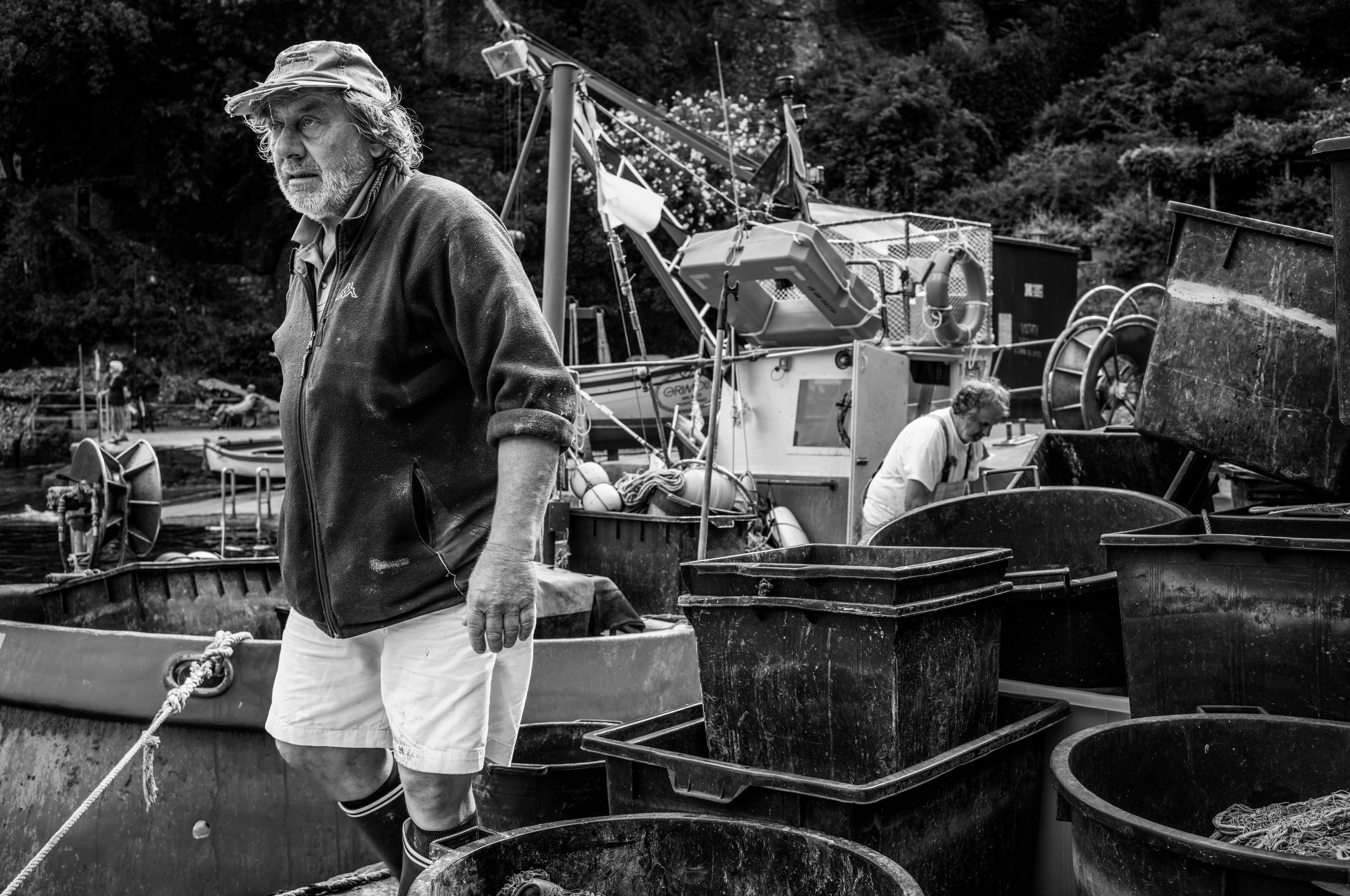 Italian fisherman Manuel and his associate Franco in front of fisher boat