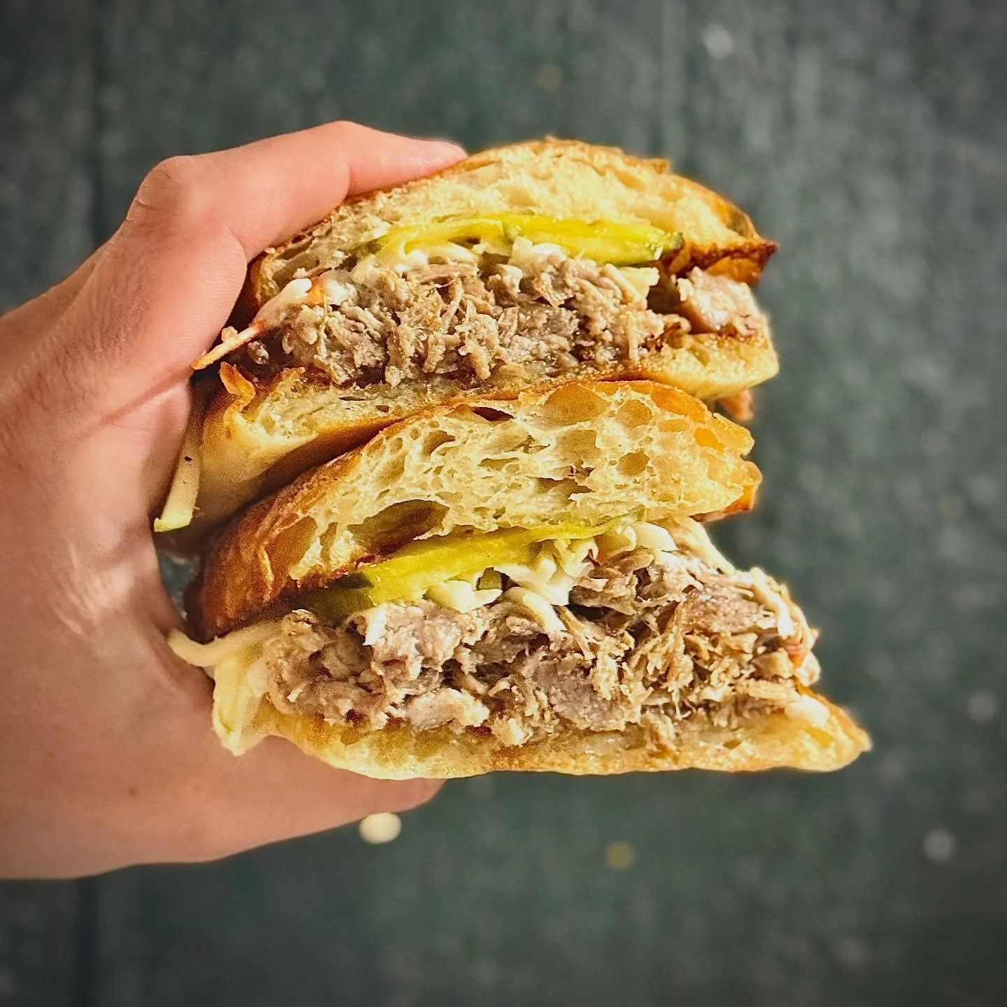 How about this Carnitas Sando?! One of a few new items on our Fall-inspired menu. 
slow-roasted carnitas, lime crema, apple slaw, bread & butter pickles, house-made ciabatta: served with house greens