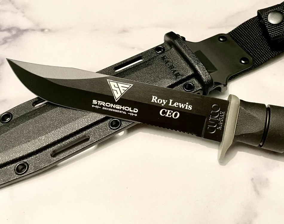 Engraved blade with a company logo and the recipient's name and title