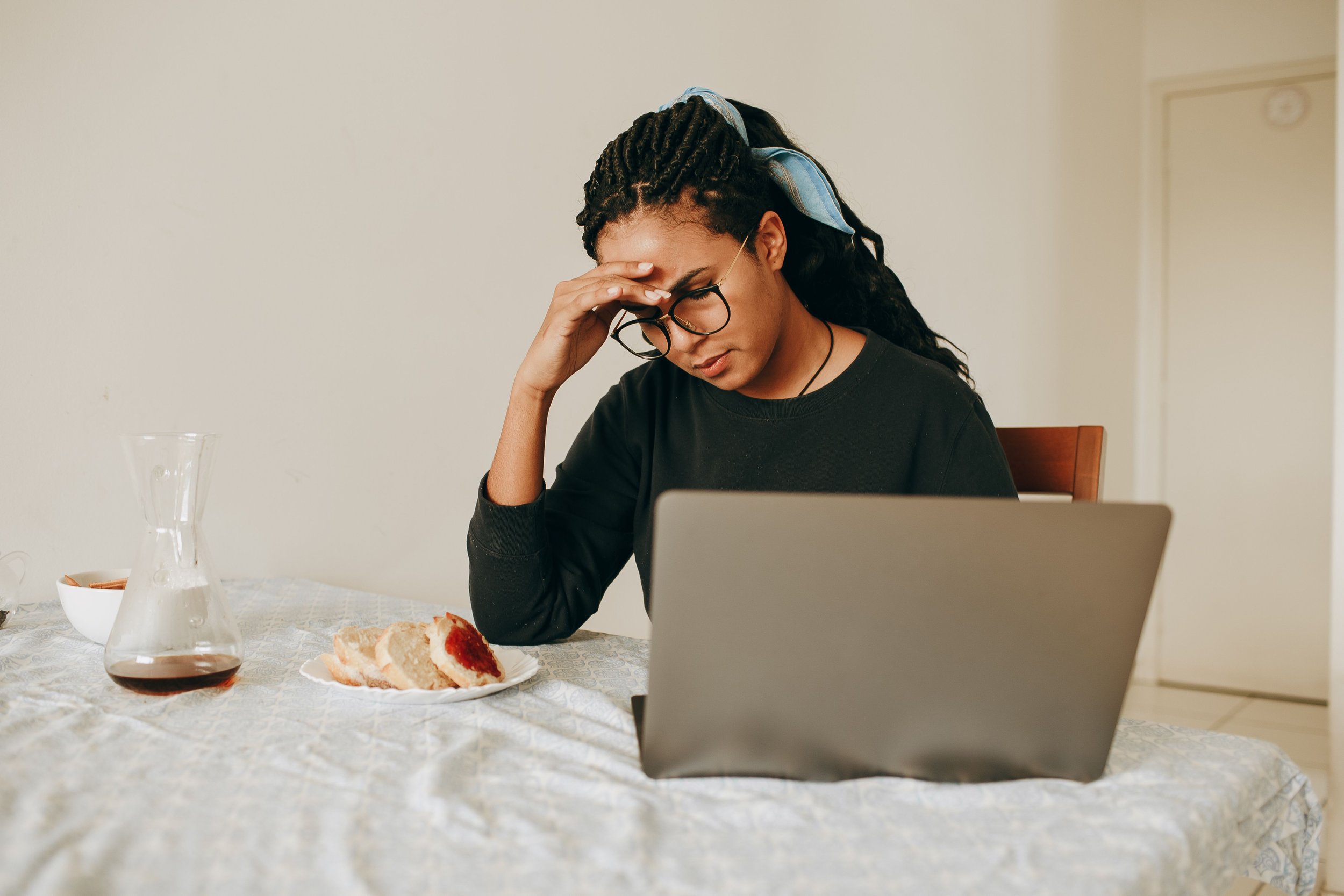 Millennial woman of color struggling with burnout in Chicago, IL