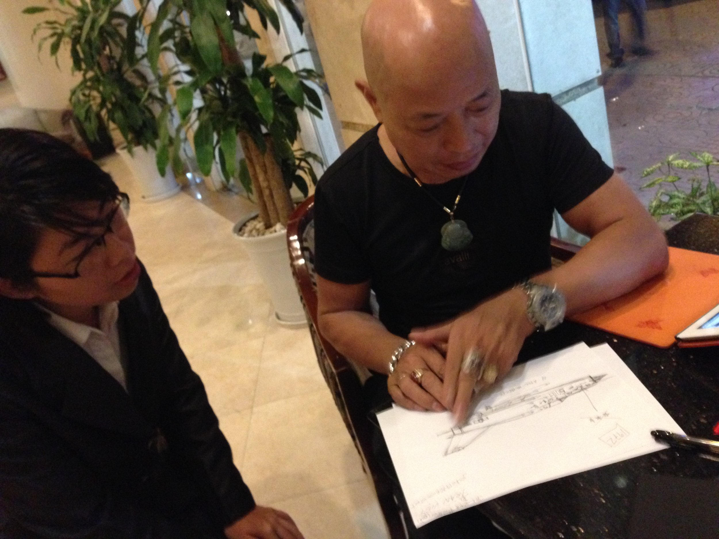 In Ha Noi with former NVAF pilot Nguyen Hong My reviewing my crude pencil sketch of his MiG-21...