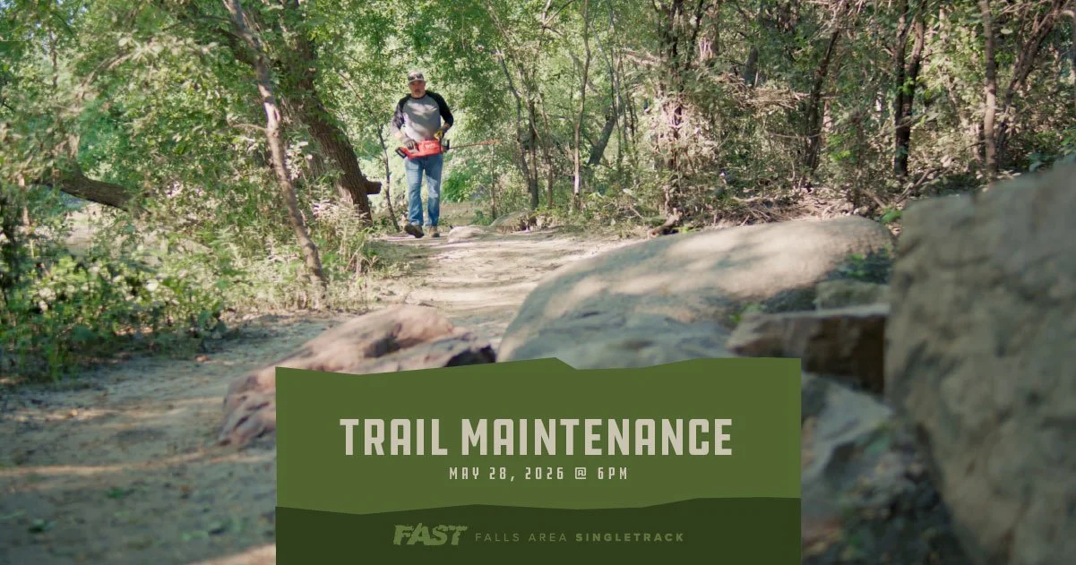 A trail crew member holding a hedge trimmer.