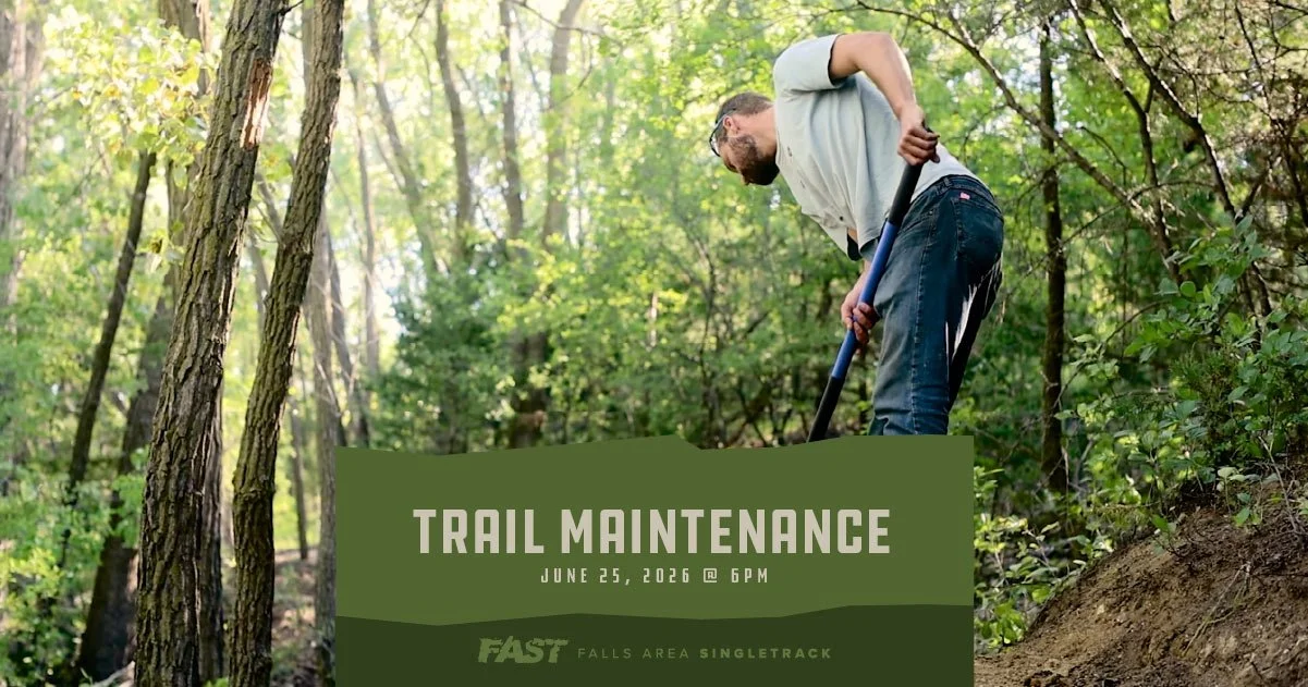 Trail crew moving dirt with a forestry tool.