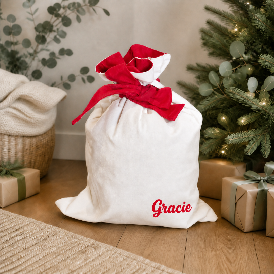 Personalised Luxe Santa Sack in natural cotton with red inner lining and a wide matching tie.