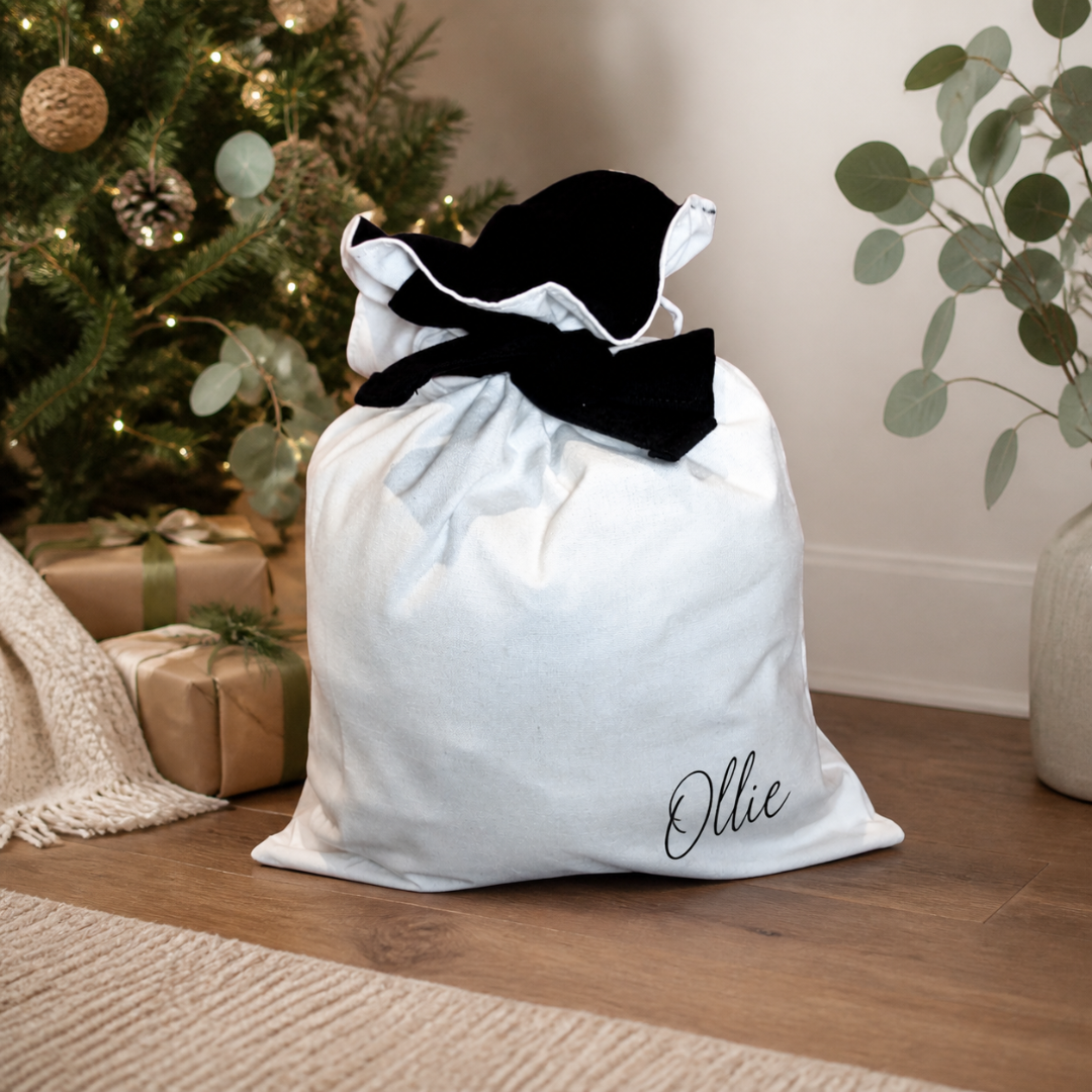 Personalised Luxe Santa Sack in natural cotton with black inner lining and a wide matching tie.