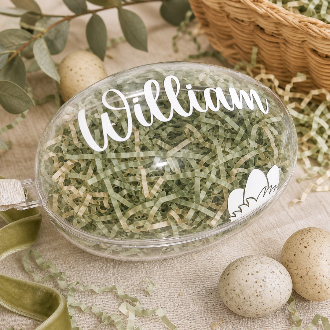 Personalised clear fillable Easter egg decorated with white satin ribbon.