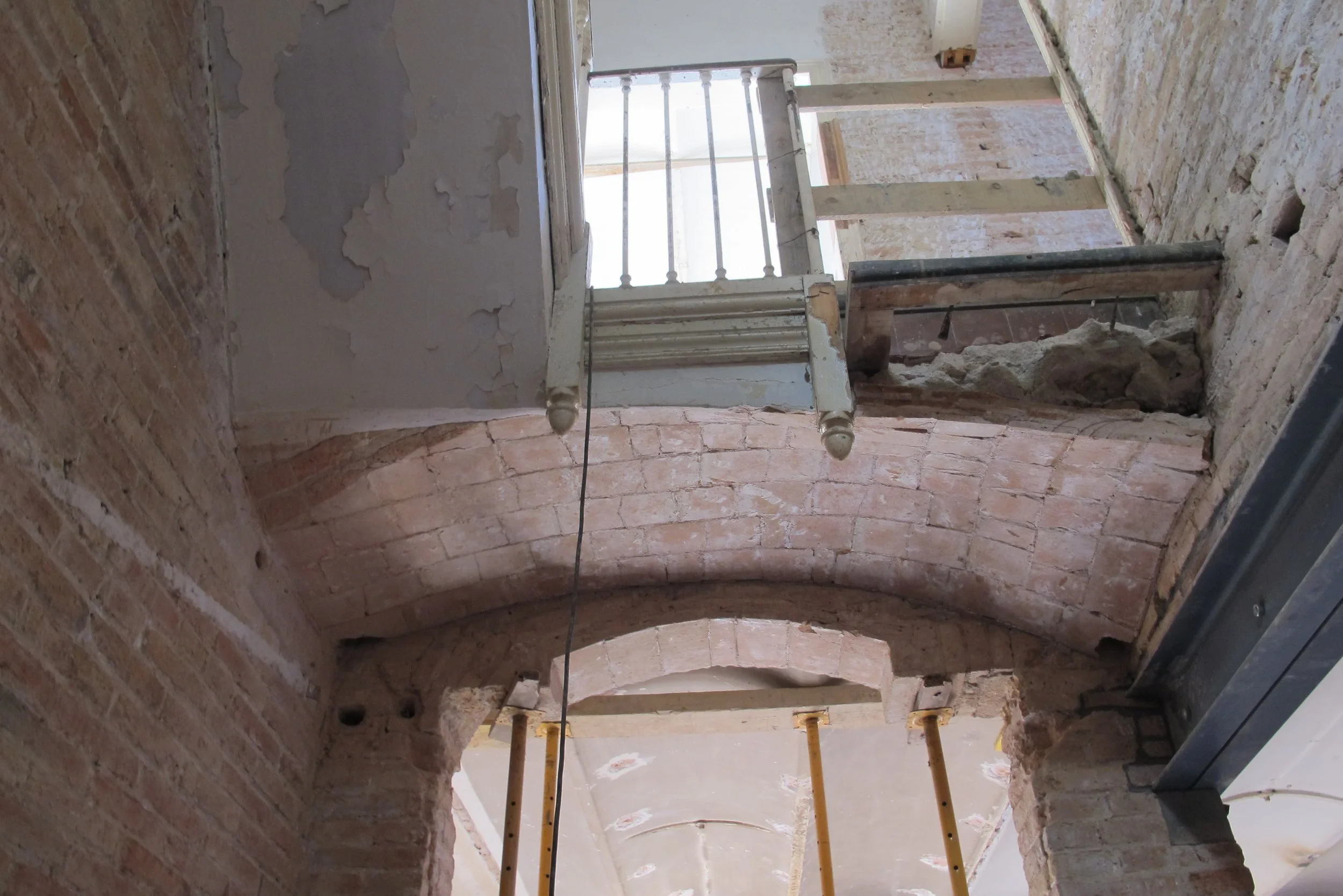 Old plaster was stripped from walls and stair structure