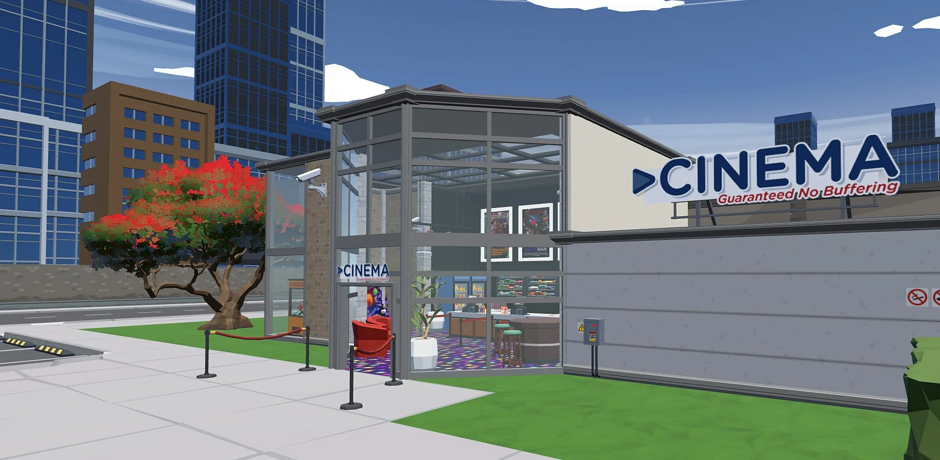 A modern city cinema building with glass walls and a sign that reads 'CINEMA' with the tagline 'Guaranteed No Buffering.' There are tall skyscrapers in the background, a tree with red and green leaves, a small grassy area, and a red mailbox outside the entrance. Security cameras are mounted on the building, and a sidewalk runs in front.