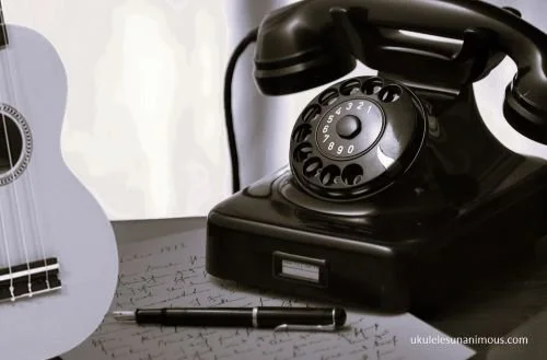 Old telephone with ukulele.