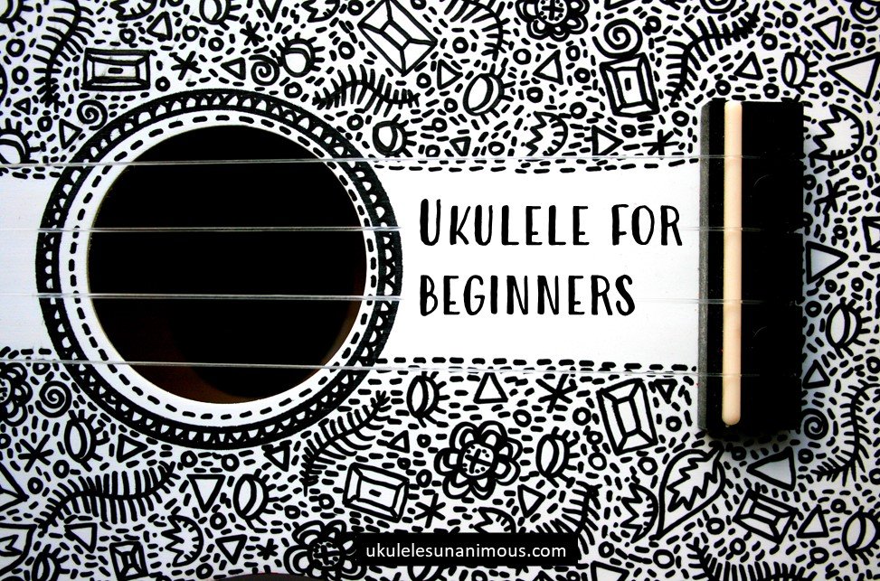 Close up of a ukulele sound hole saying ukulele for beginners.