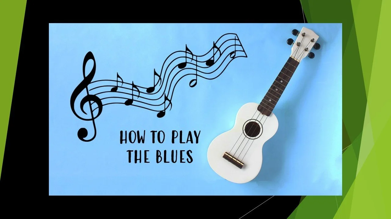 White ukulele on blue background.
