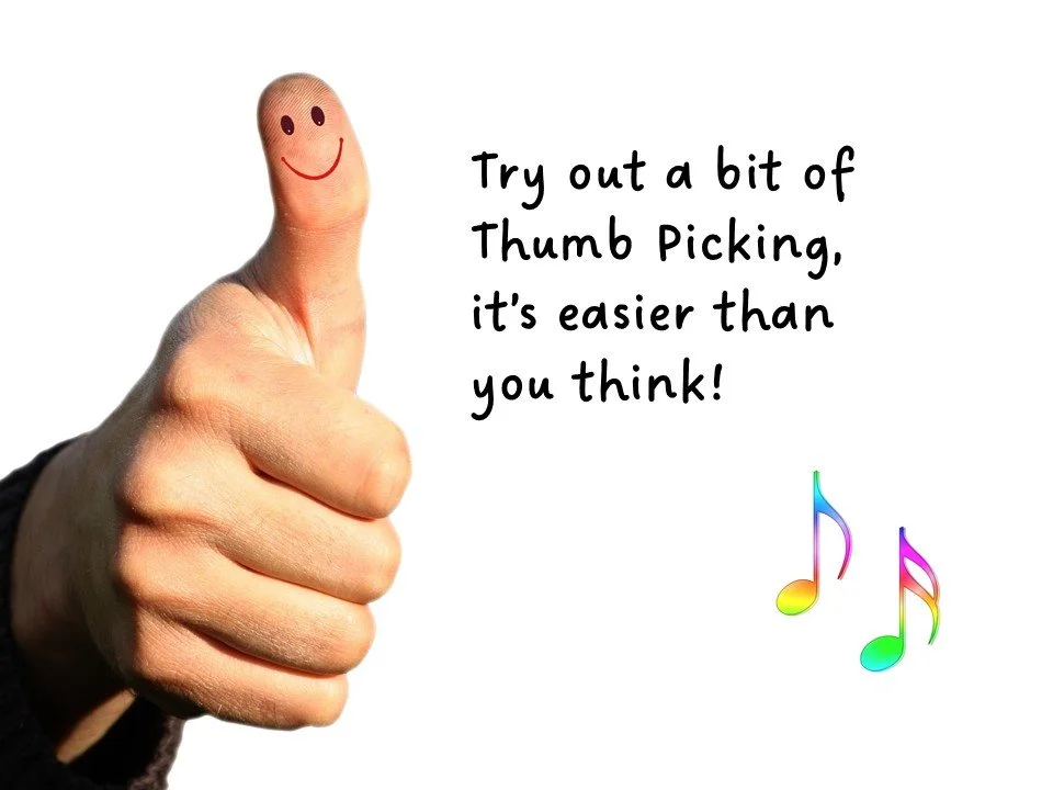 Close up of a thumb with a smiley face drawn on it.