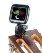 Digital tuner attached to a ukulele.