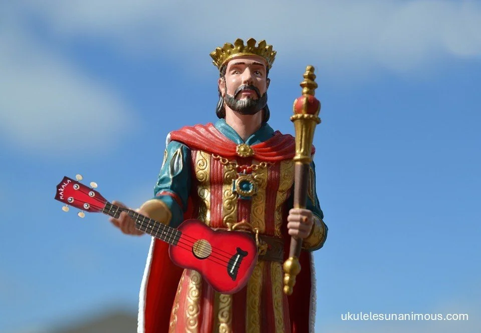 King holding a red ukulele and sceptre.