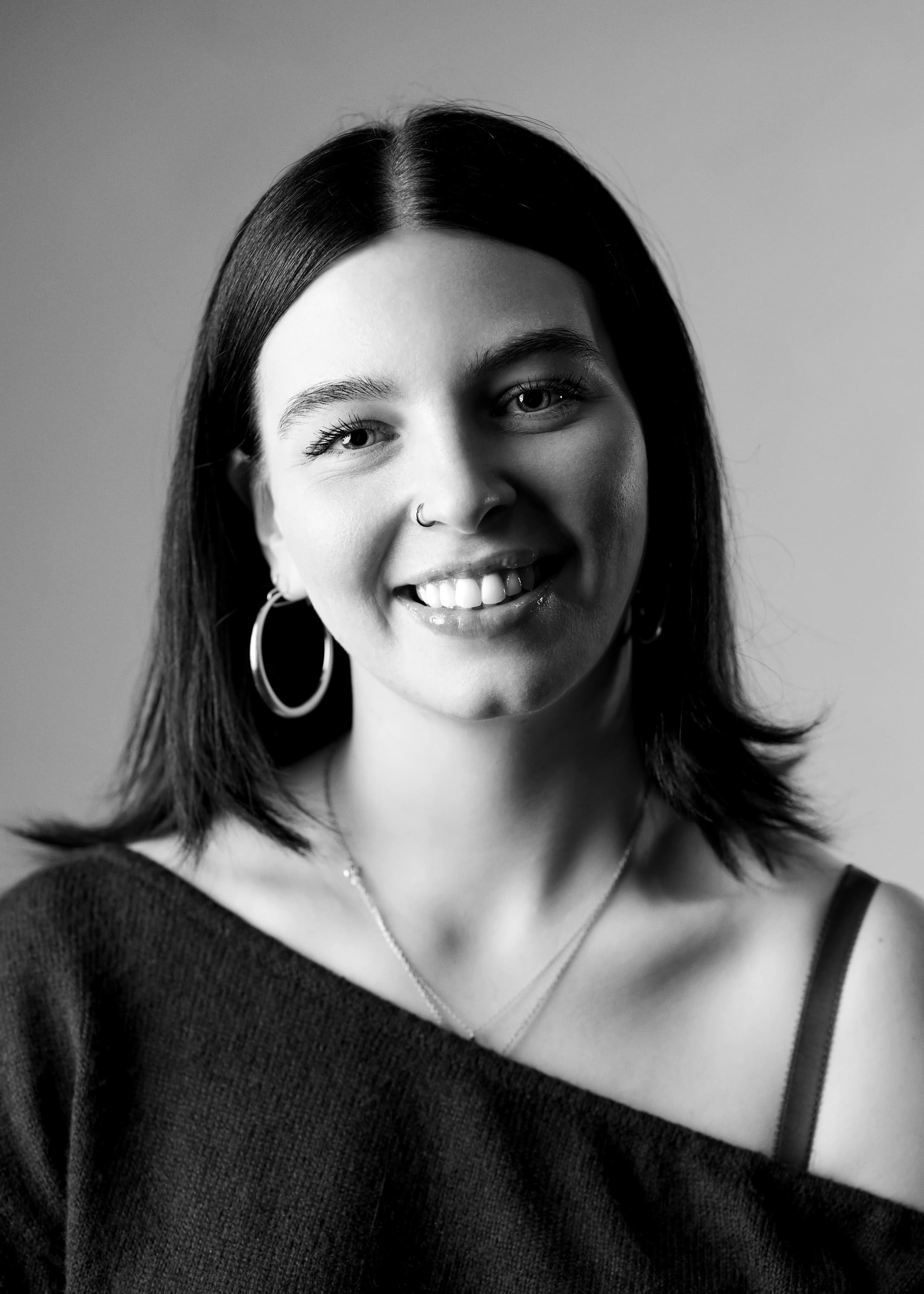 Black and white portrait of a woman smiling and looking into the camera