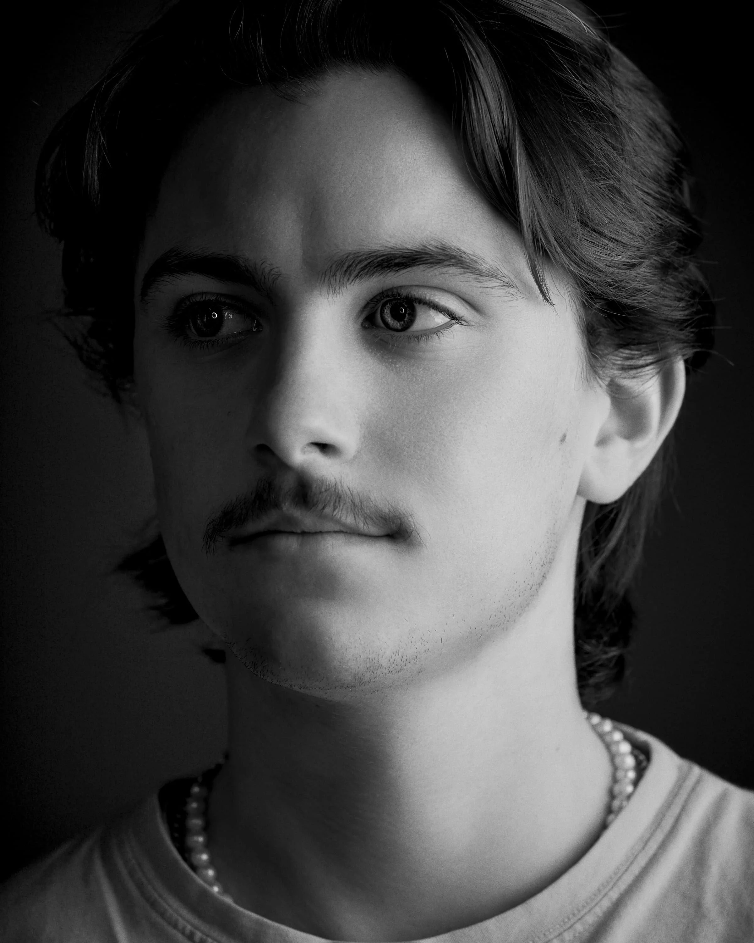 Black and white portrait of a man looking away from the camera