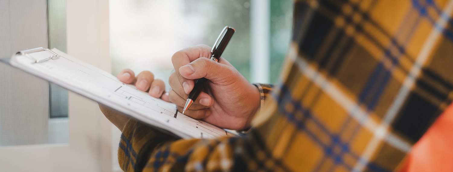  A detail photo of a man making a detailed checklist. If you're looking for the best home concierge in Colorado to help you upgrade and maintain your home, WillowHome is here for you. 