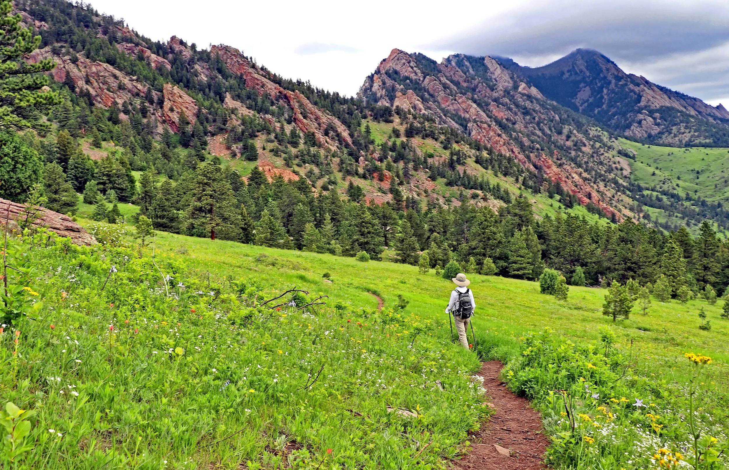  A woman hikes the Goshawk Ridge trail in Boulder. Looking for lesser known or hidden gem trails in Boulder? Check out our Ultitmate Guide to Boulder Hikes and discover your next favorite hiking trail.  