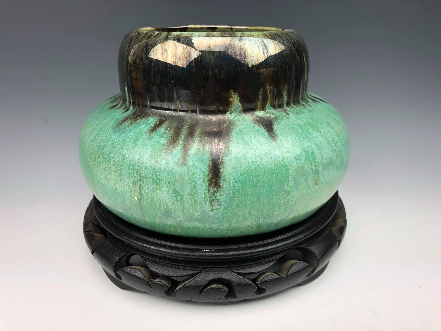 A double-gourd form vase in a black flamb&eacute; over a green crystalline glaze. Fulper Pottery of Flemington, New Jersey. Circa 1915.

The Drake Hall Collection