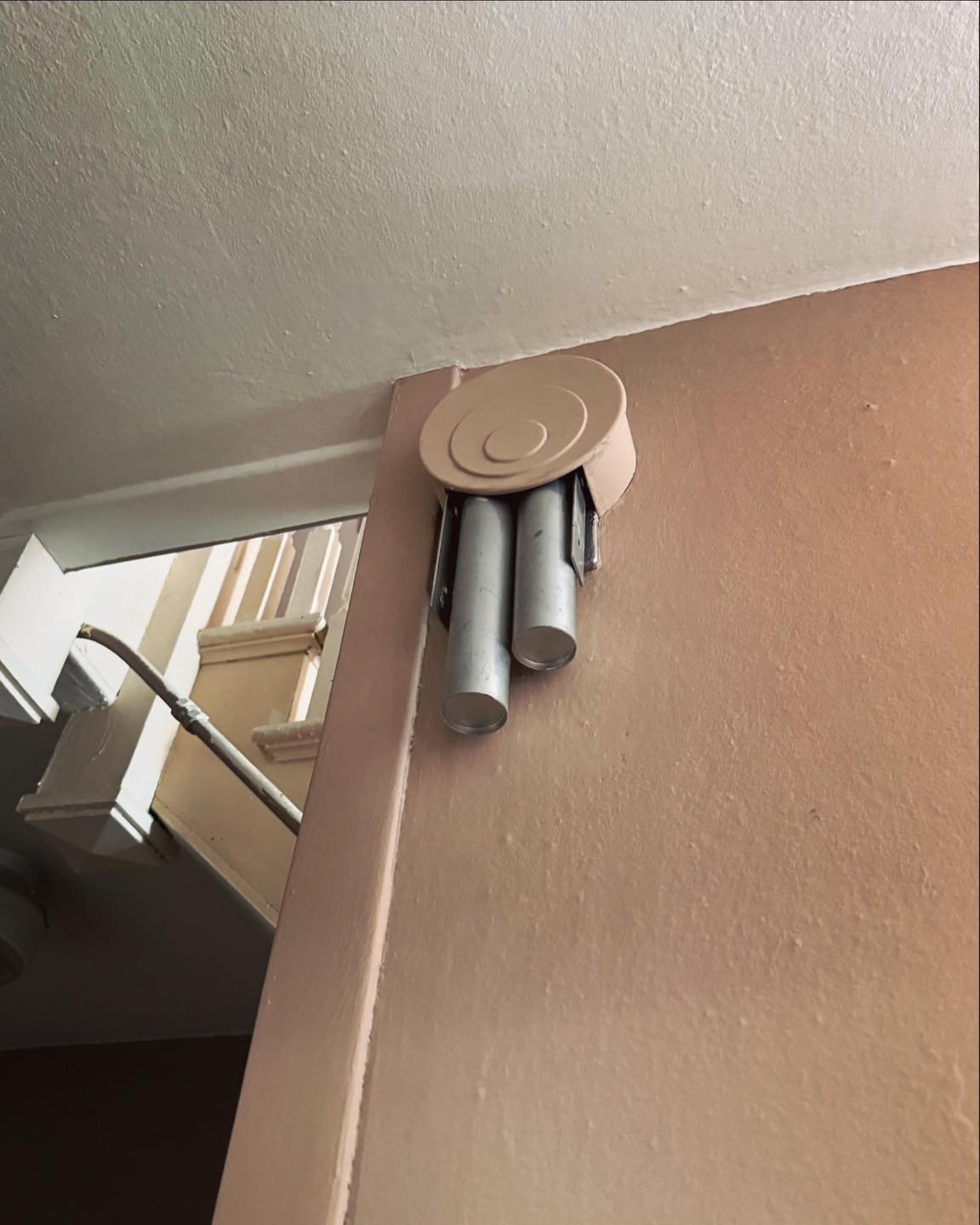 Doorbell in the rear service stairs. Looks to be from the 1940s