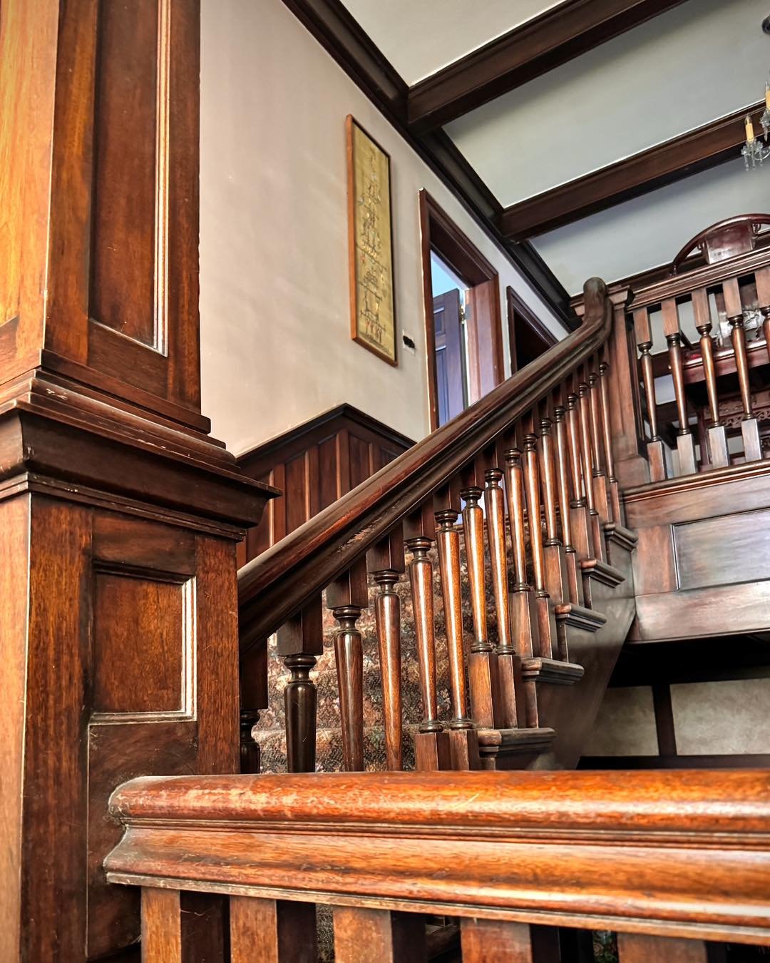 Ascending the mahogany staircase.