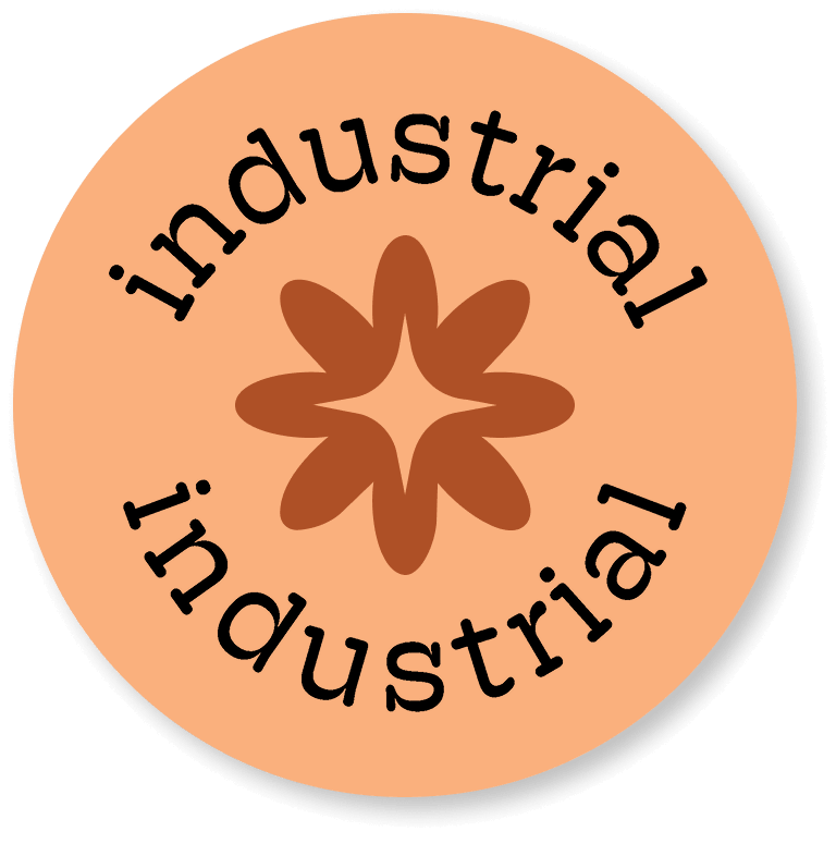 Pink round sticker that says "industrial"
