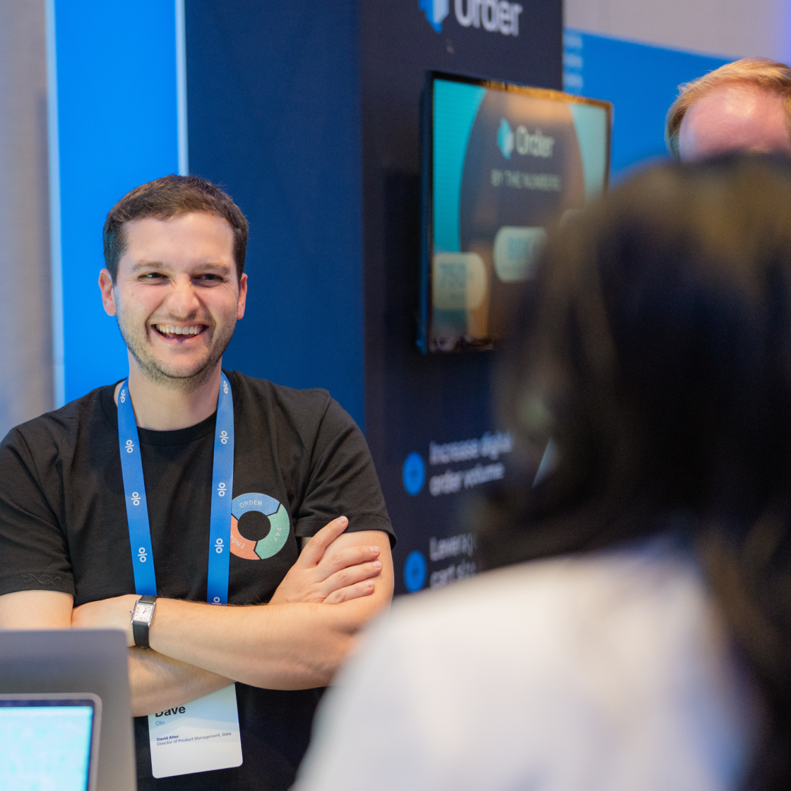 Man smiling in front of demo booth
