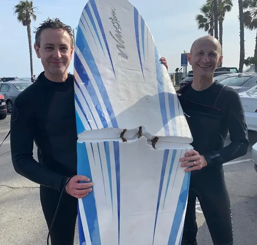 Surf lesson taking place in the calm waters south of the Santa Monica Pier