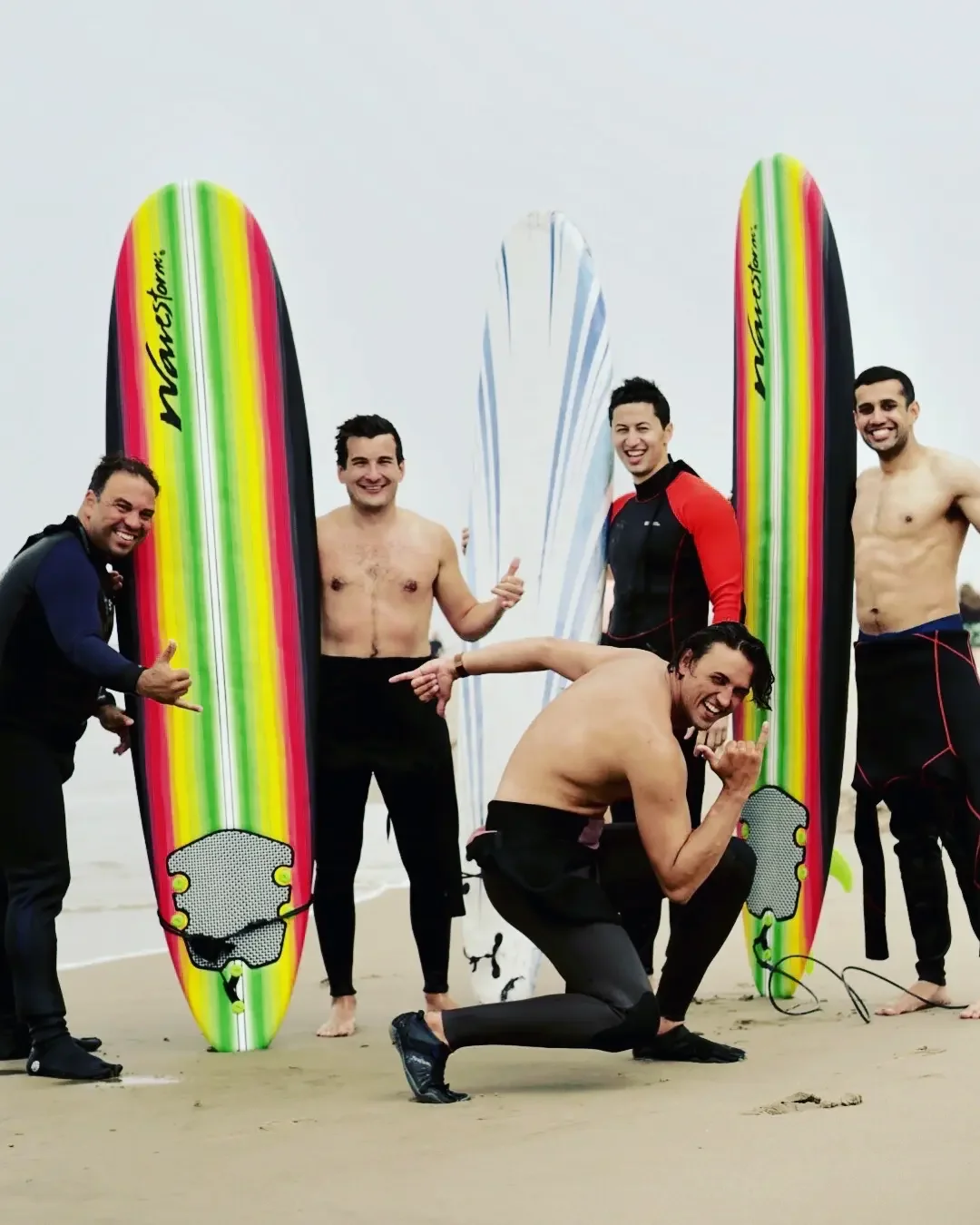 Friends participating in a group surf lesson together in Santa Monica