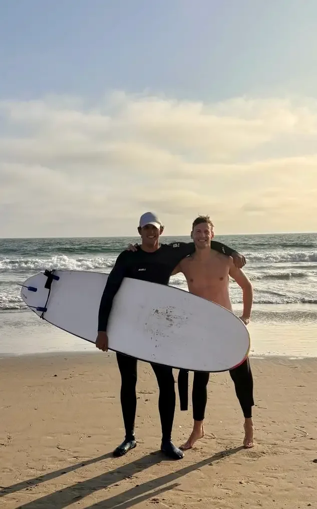 Student learning how to surf during a surf lesson at Santa Monica Beach.