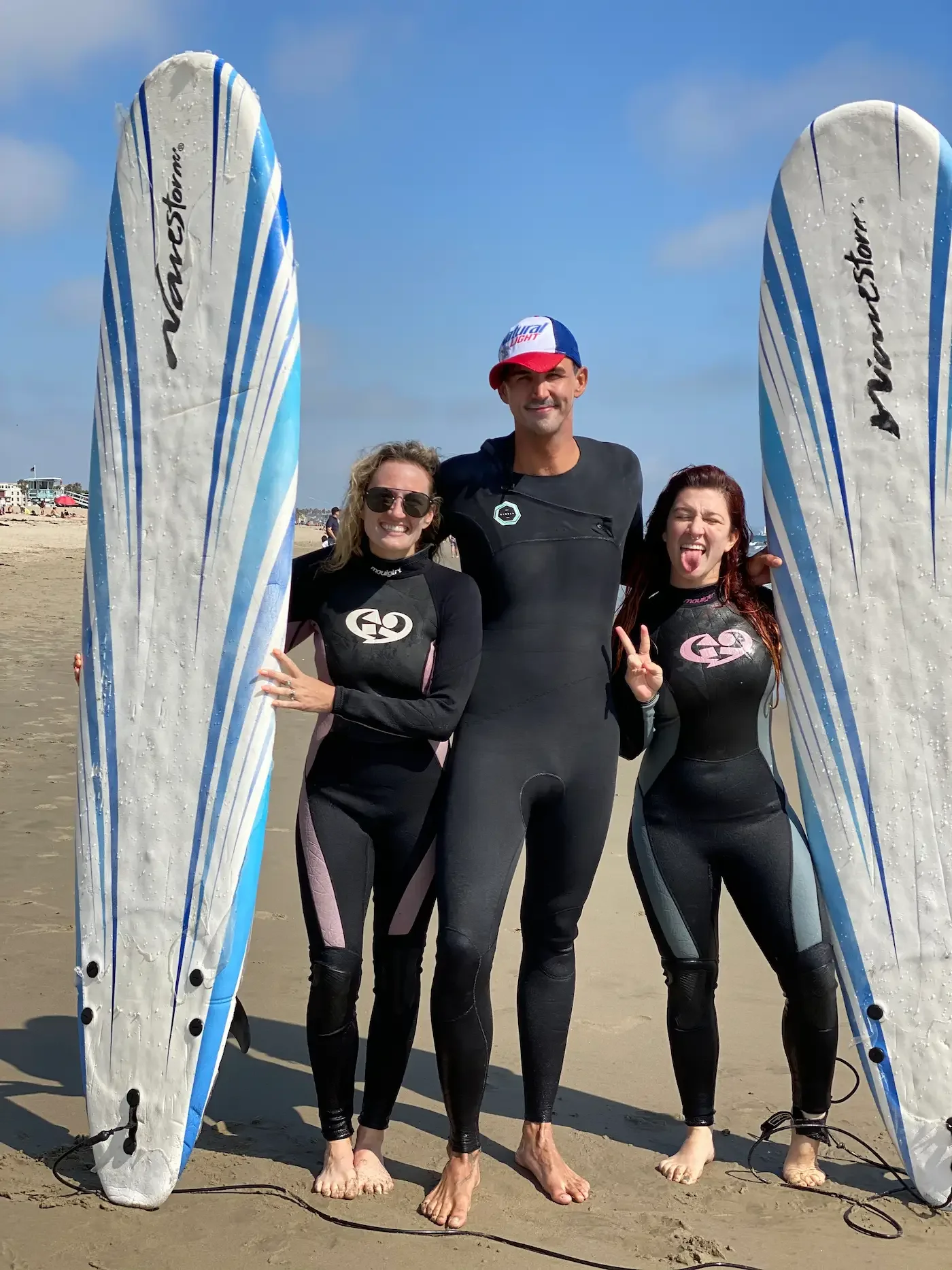  Surf instructor assisting a beginner surfer in shallow water at Santa Monica California