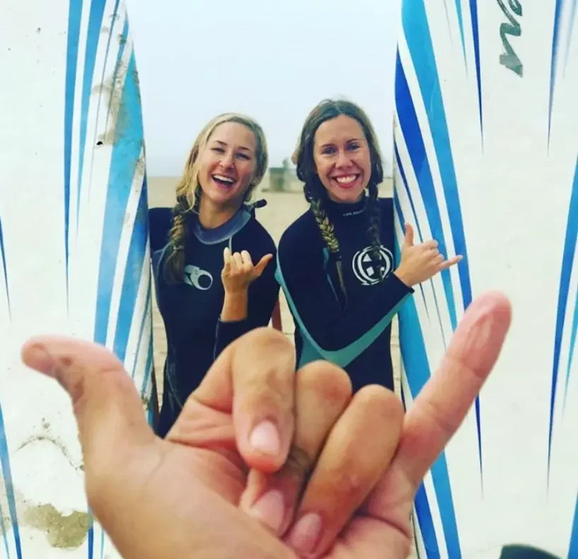 Child learning to surf safely with an instructor in Santa Monica