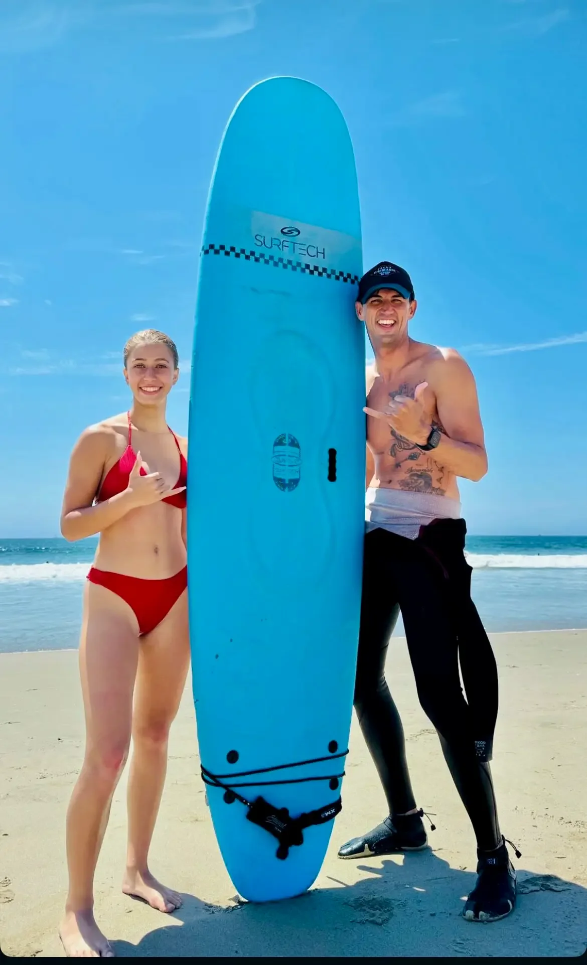 Family learning to surf together during a Los Angeles surf lesson