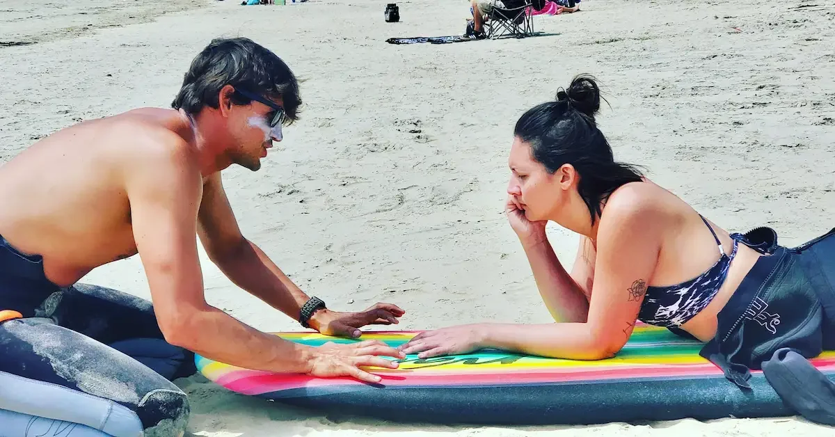Surf instructor teaching beginner technique at a Santa Monica surf school.