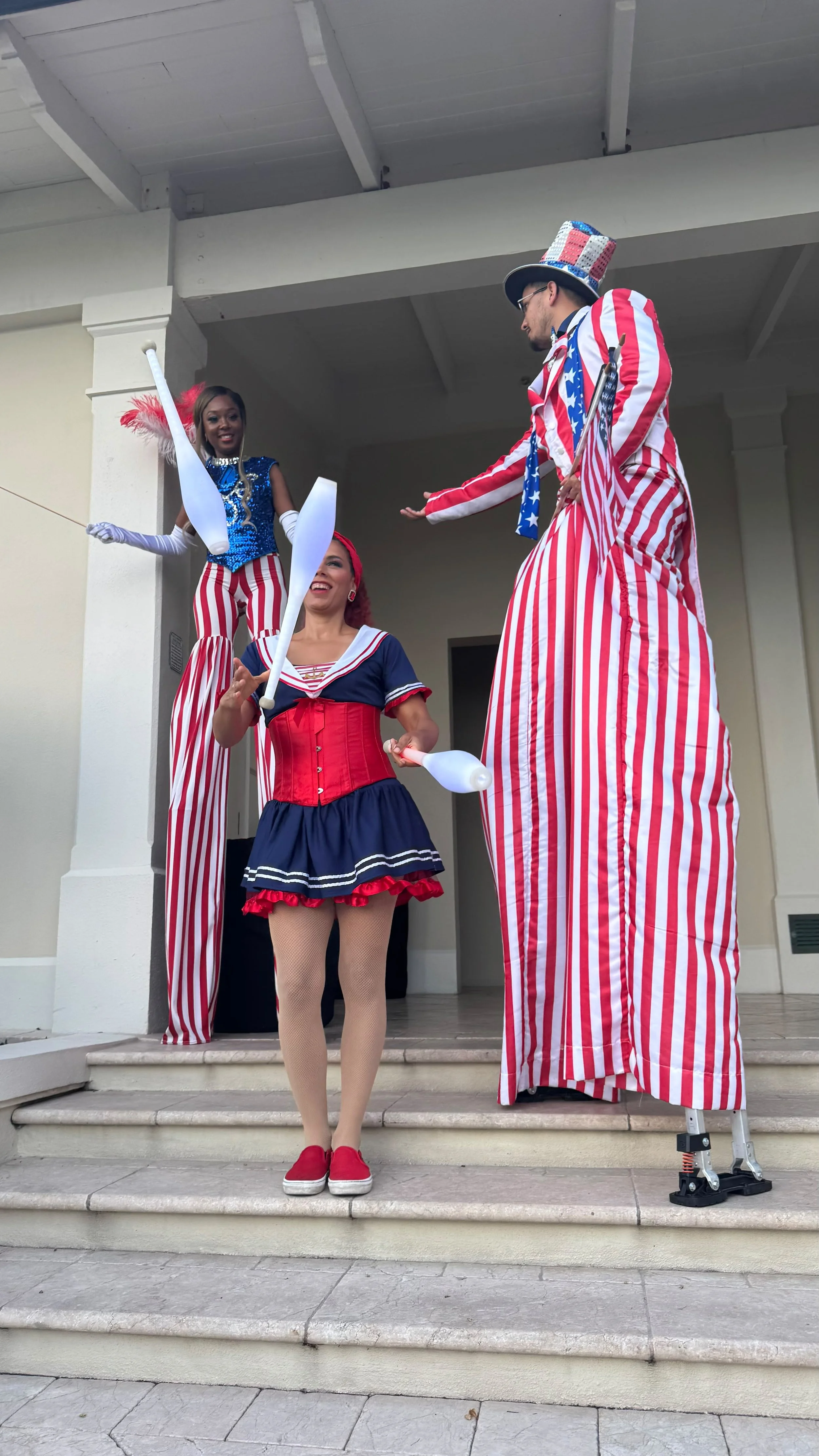 4th of July Juggling LED Clubs with Stilts Walkers Red White and Blue