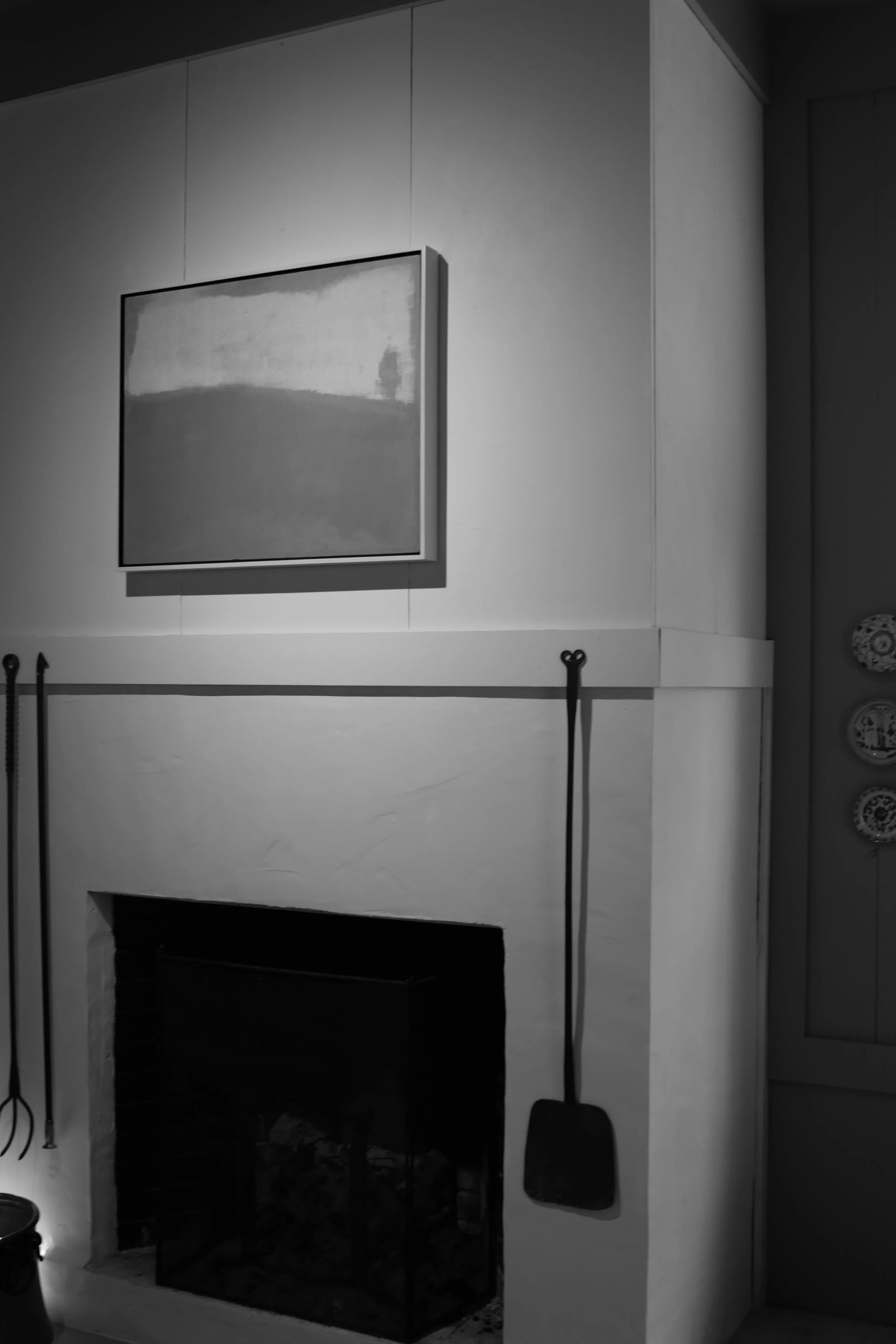 The artist's painting studio interior, painting over fireplace.