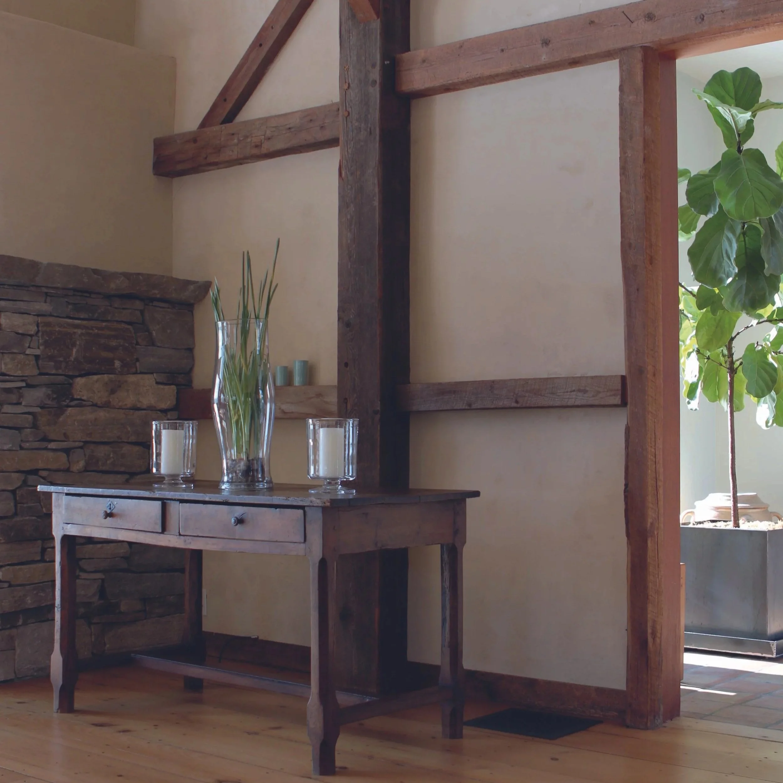 Room interior with barn beams an old table.