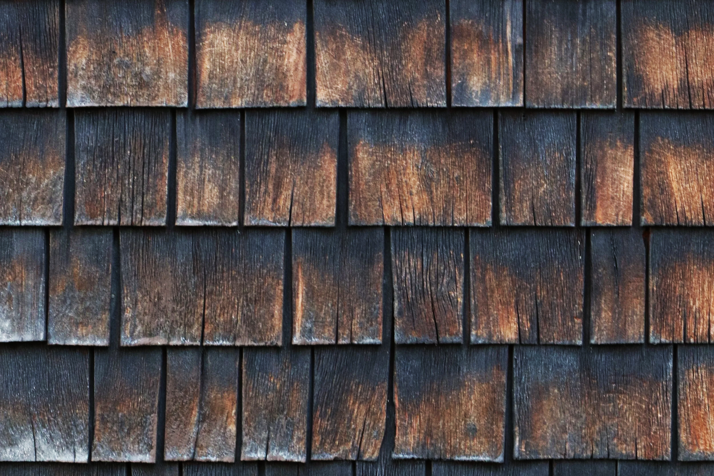 Photograph by Glenn Suokko of the cedar shingled facade of an old out building.