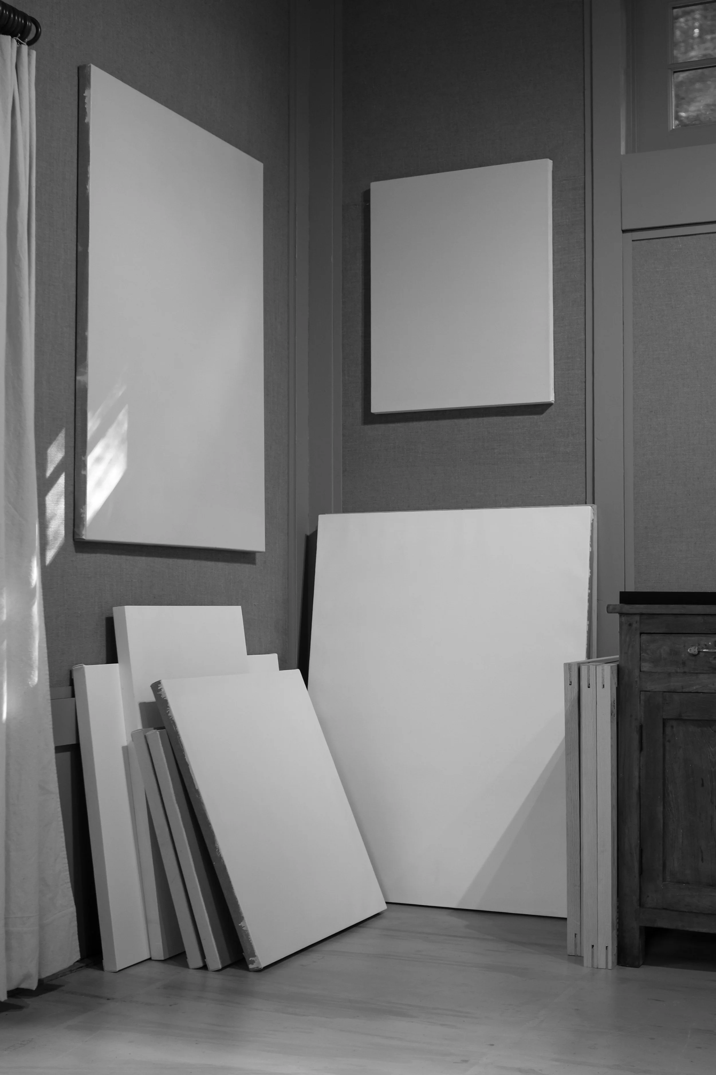 The artist's painting studio interior, blank canvases.