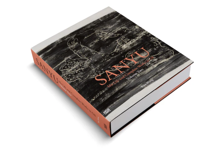 Sanyu, Volume Two on a table illustrating its thickness.