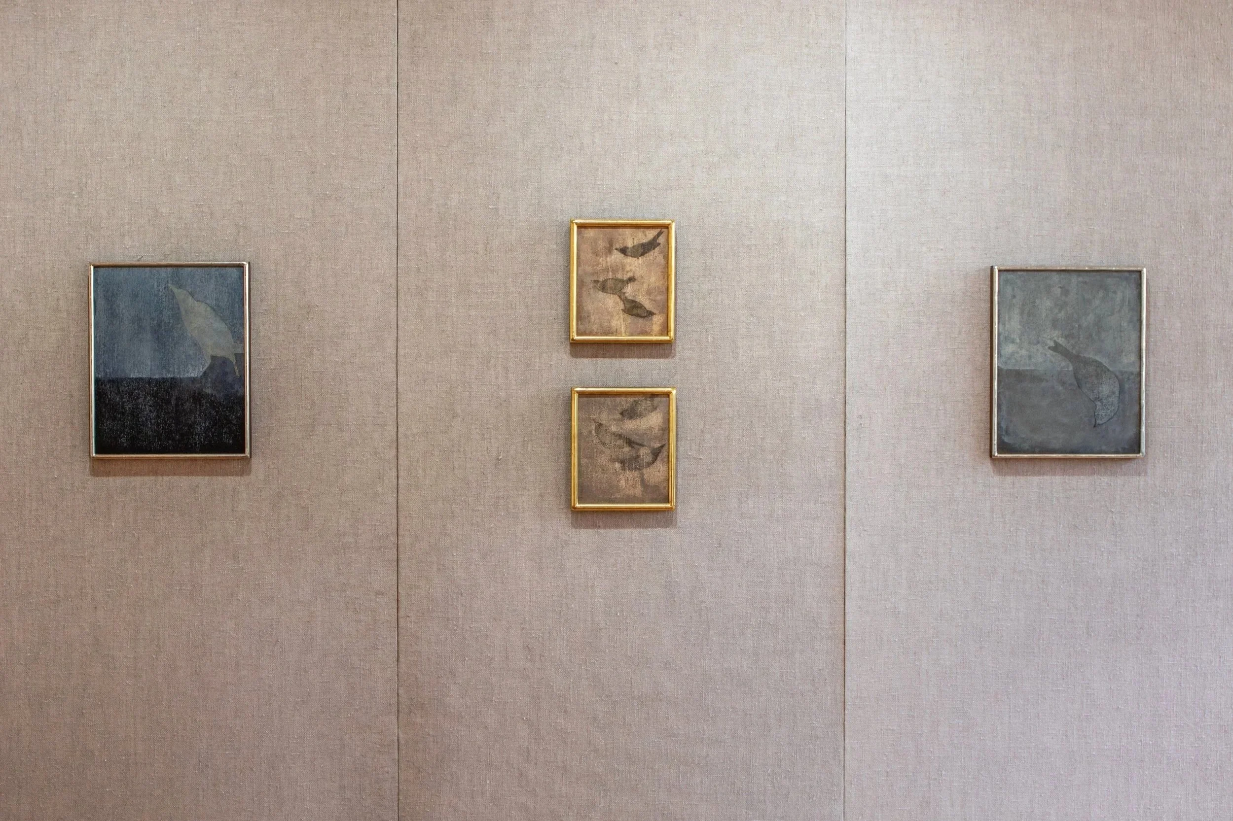 Four framed oil paintings installed on linen panels in the gallery.