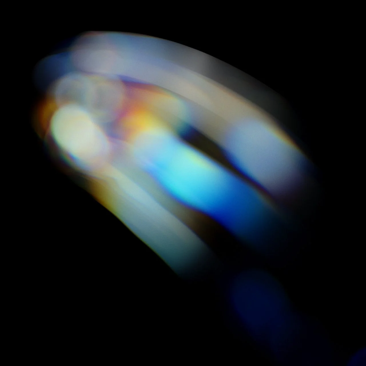 Abstract image with blurred multicolored lights against a dark background.
