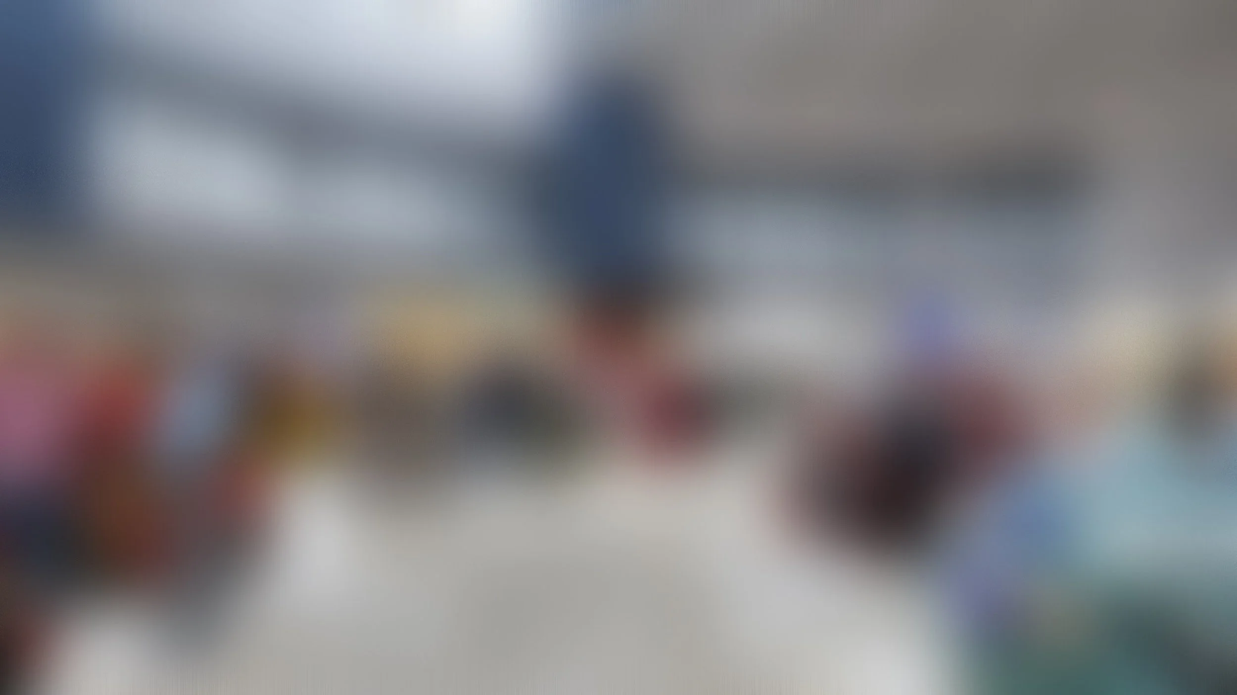blurred image of an indoor public space with people and a high ceiling
