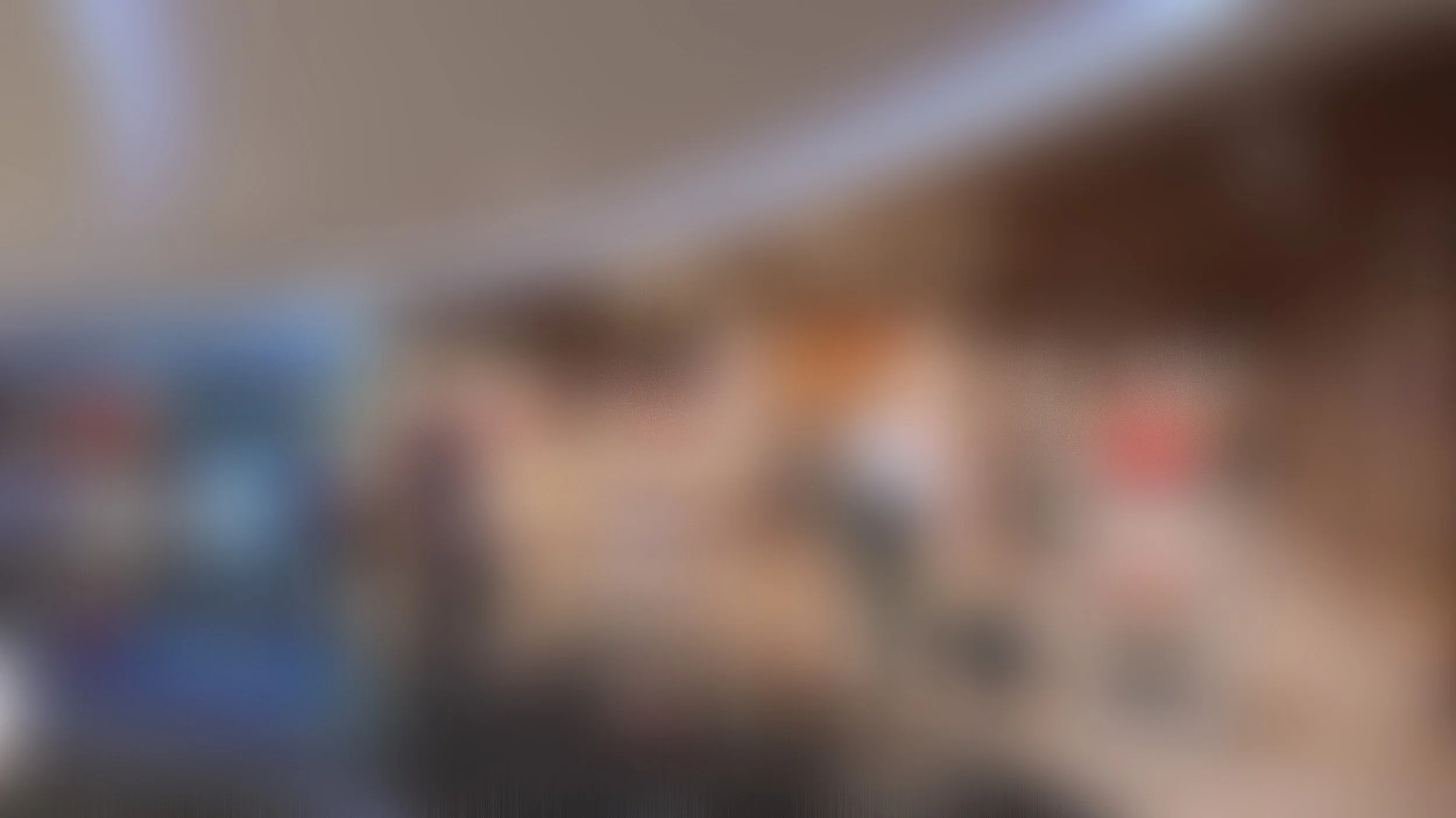 Blurry indoor scene with people and furniture